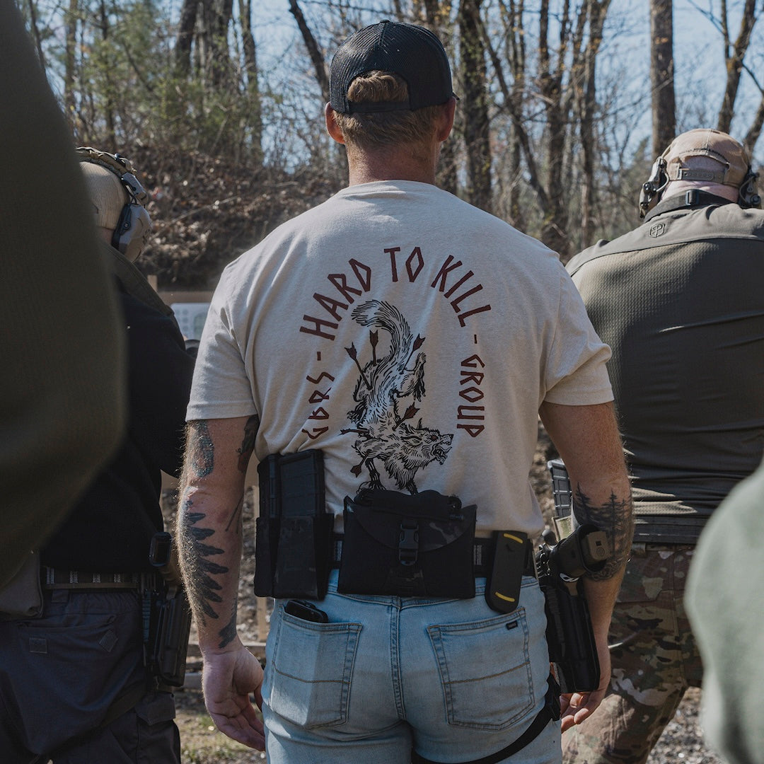 Model wearing the GBRS Group Hard to Kill Death Grip Short Sleeve in an outdoor range environment 