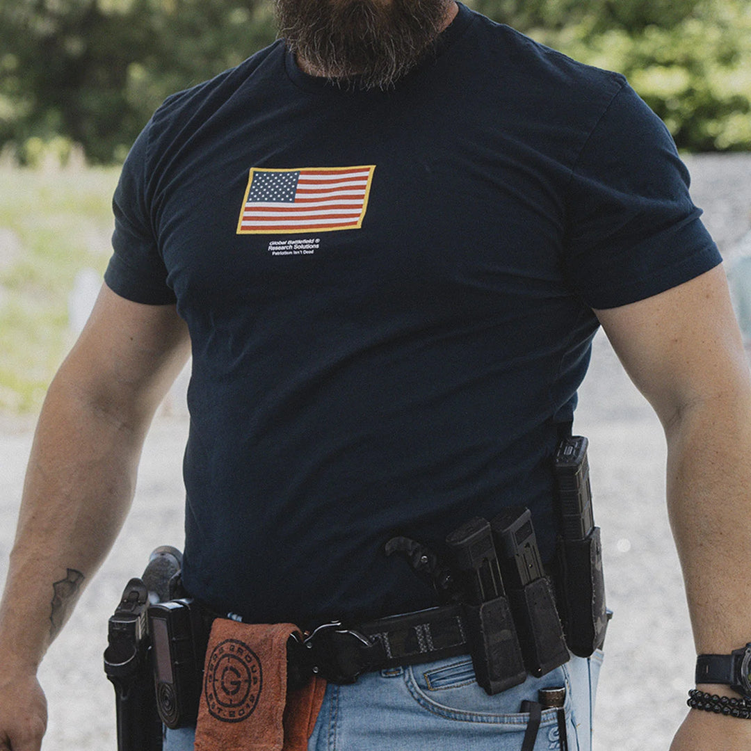 Person wearing the GBRS Group Front and Center Navy Short Sleeve Shirt walking outdoors.
