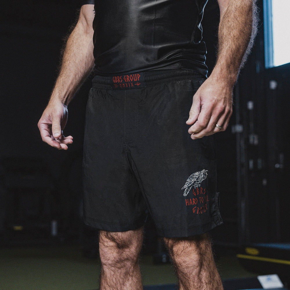 Person wearing GBRS Group Hard to Kill Fight Shorts in a gym setting