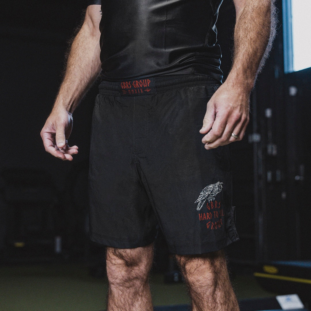 Person wearing GBRS Group Hard to Kill Fight Shorts in a gym setting