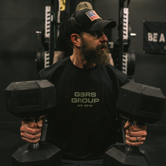 Man performing a workout while wearing the GBRS Group Instructor Short Sleeve Shirt