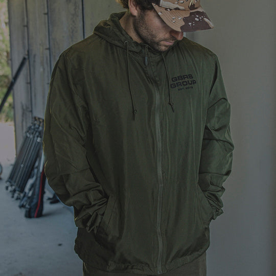 Man wearing the GBRS Group Instructor Windbreaker Jacket outdoors
