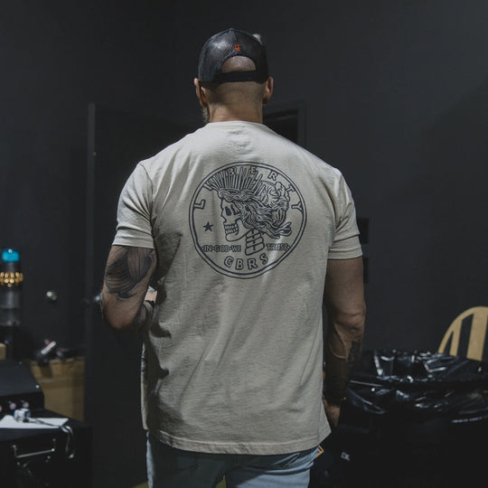 Man wearing the GBRS Group Lady Liberty Short Sleeve Shirt, walking out of a room.
