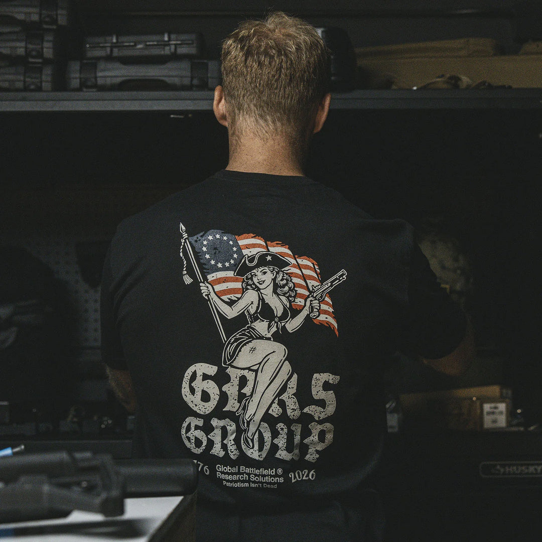 Person wearing the GBRS Group Lead and Lace Short Sleeve Shirt with a graphic design on the back, featuring an American flag and text.