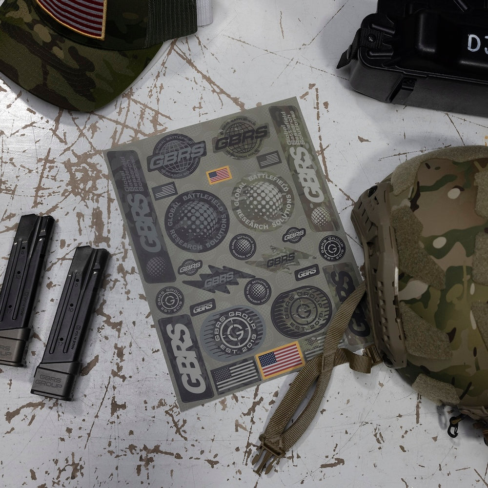 GBRS Group Multicam Capsule Sticker Sheet laid on a table surrounded by tactical gear.