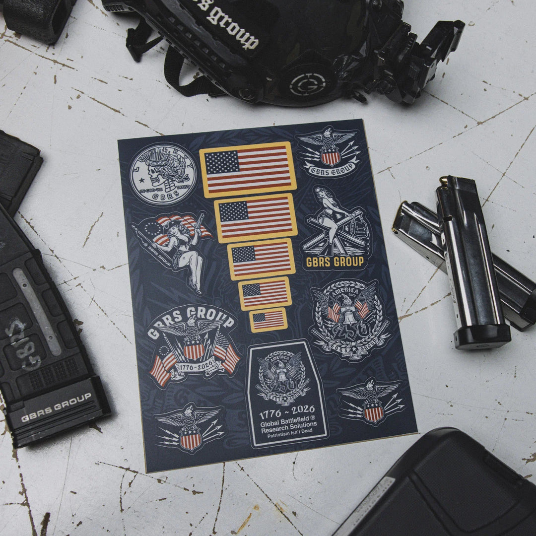 GBRS Group Patriotism Isn't Dead Sticker Sheet on a work table with firearm magazines surrounding it.