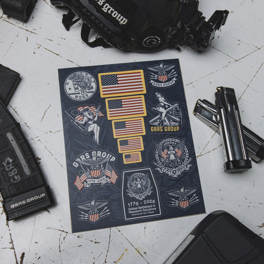 GBRS Group Patriotism Isn't Dead Sticker Sheet on a work table with firearm magazines surrounding it.