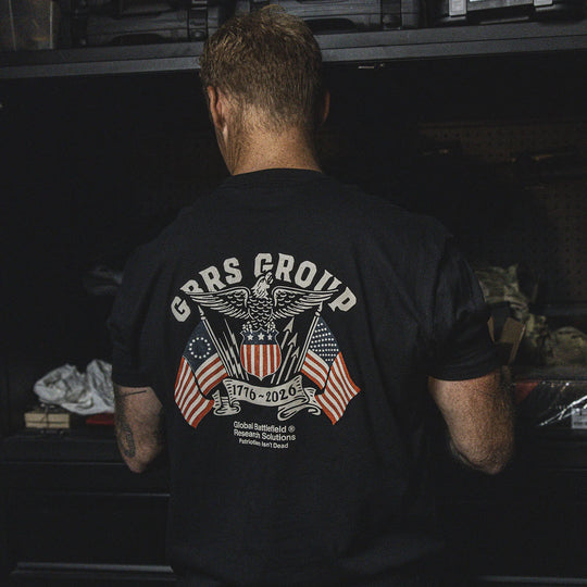 Person wearing the GBRS Group Test of Time Short Sleeve Shirt, standing in a workshop.