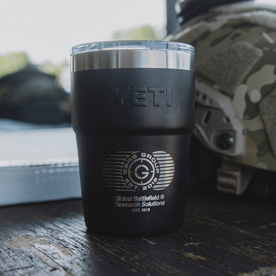 The GBRS Group 16 oz Yeti Rambler next to a helmet on a table