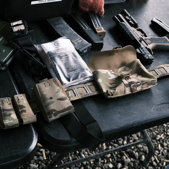 GBRS Group IFAS (Individual First Aid System) Pouch - Showing on a belt, laying on a table, ready to fill