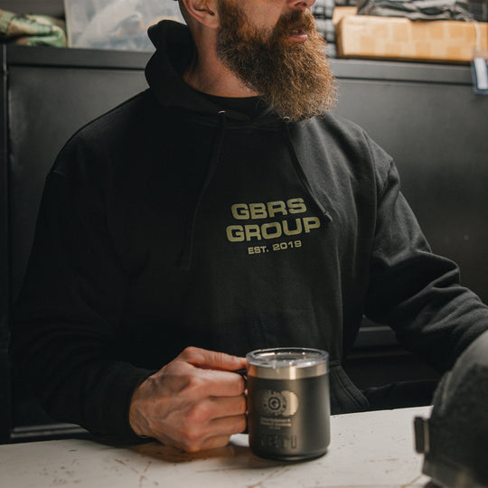 GBRS Group Instructor Pullover Hoodie, pictured in black in a lifestyle setting showing the front print design