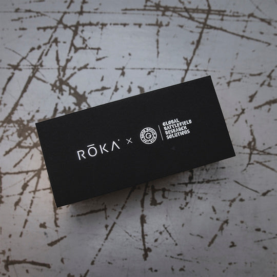 GBRS Group and Roka logos on a black box, resting on a textured surface