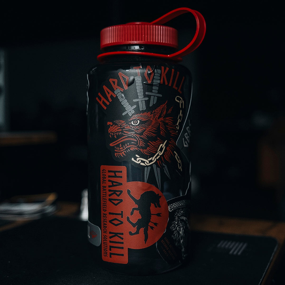 GBRS Group Hard to Kill Nalgene Water Bottle with GBRS Hard to Kill Stickers covering the bottle in a gym setting